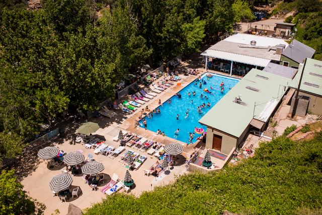 An aerial view of the spring-fed pool and the resort below the canyon walls